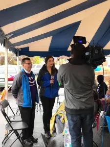 Dr. Bradley Dykstra TV interview under blue and white stripped tent.